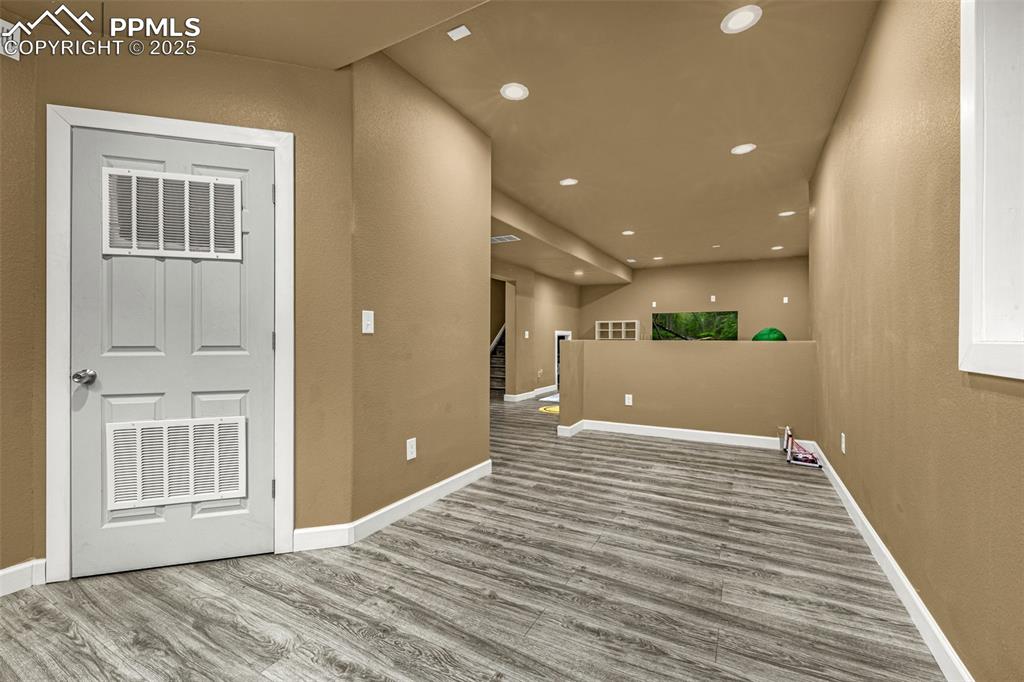 Image 32 of 45: Spare room with recessed lighting, light wood-type flooring, stairway, and 