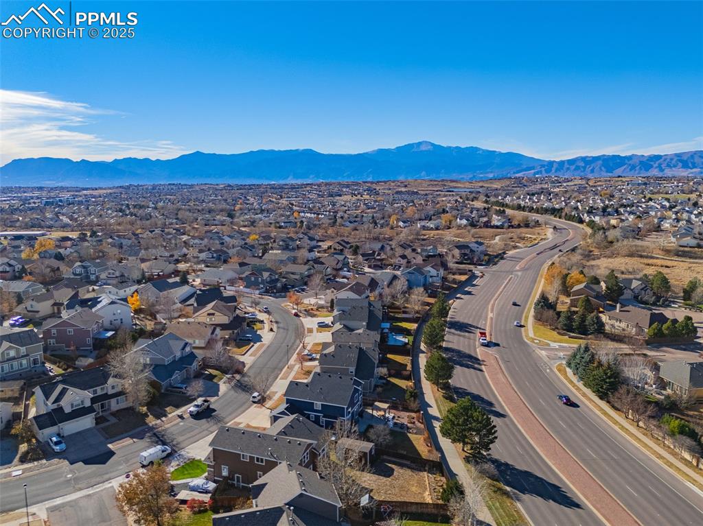 Image 45 of 45: Aerial perspective of suburban area with a mountainous background