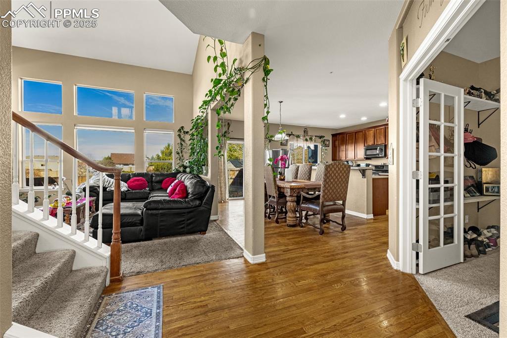 Image 7 of 45: Entryway with stairs, dark wood finished floors, and recessed lighting