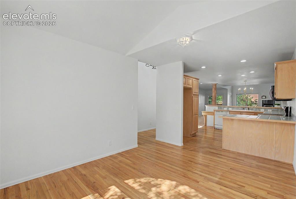 Image 5 of 39: Front Room looking into kitchen