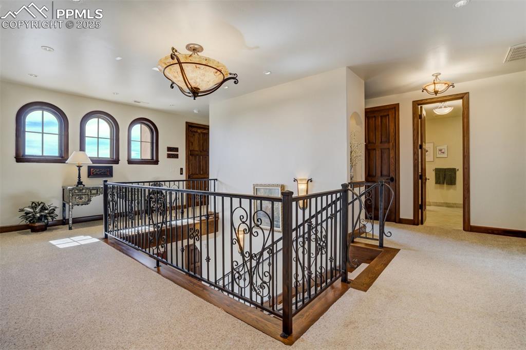 Image 32 of 50: Arched windows above and second floor elevator landing with wheelchair acce
