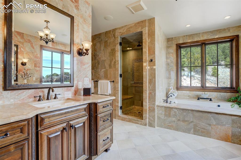 Image 37 of 50: Primary bathroom with steam shower, soaking tub and walk-in closet