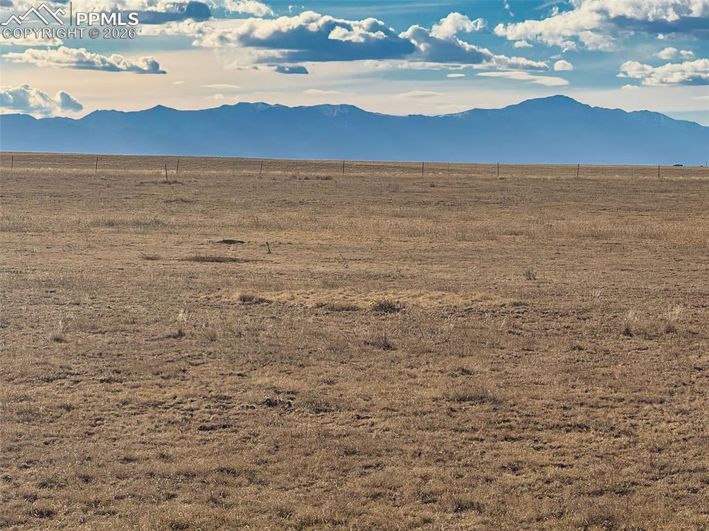 Caption: Mountain View – Distant Peaks – Broad view toward the Front Range with the mountains forming a sceni