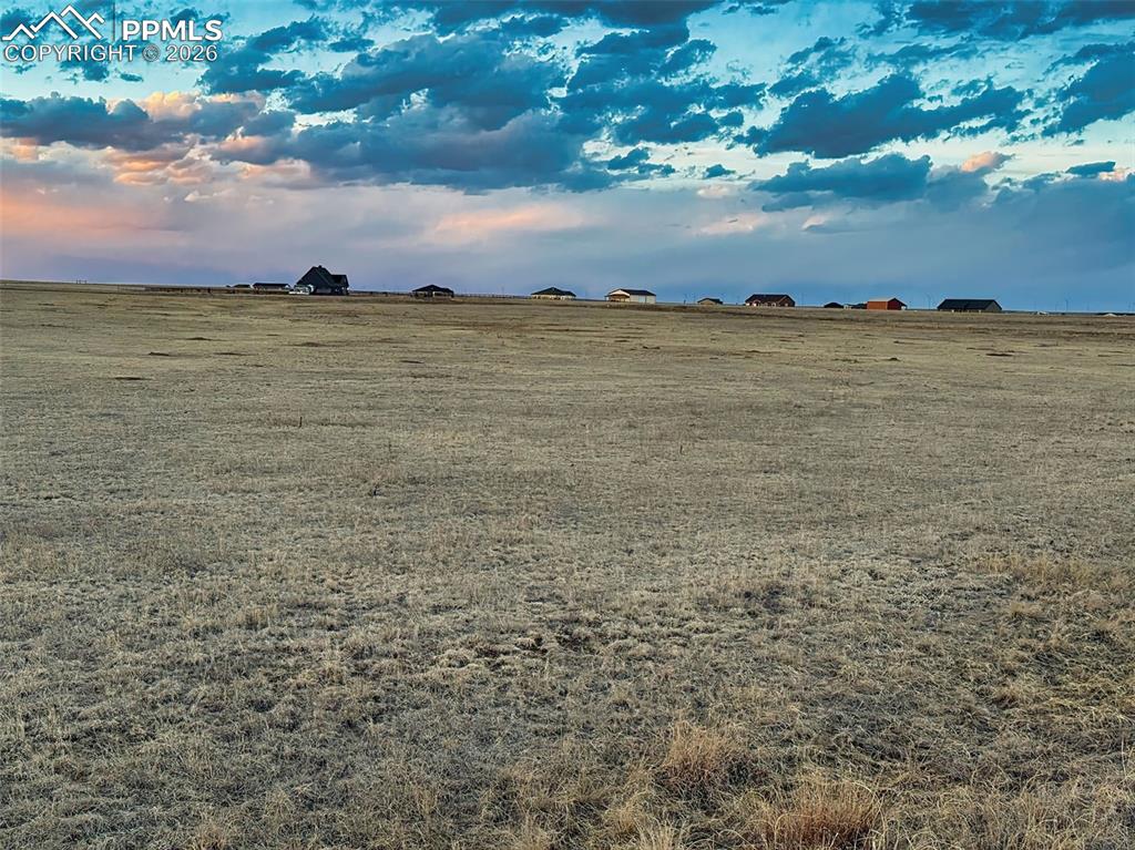 Image 9 of 12: Lot View – Surrounding Homes in Distance – Ground-level perspective showing