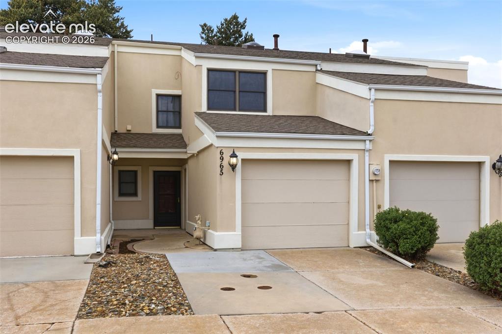 Image 1 of 50: Stucco exterior featuring multiple attached garages, a private entry, dark-