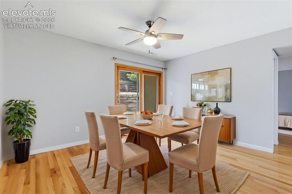 Image 13 of 50: Virtually staged Dining area featuring hardwood flooring, a ceiling fan wit