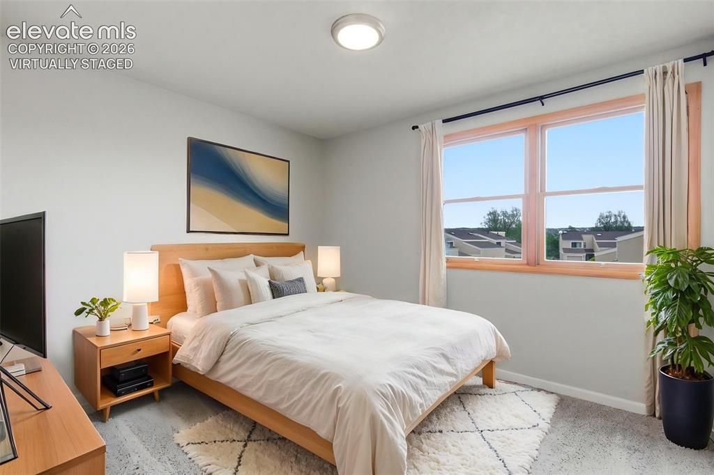 Image 20 of 50: Virtually staged -
Light-filled room featuring a broad window, light-toned