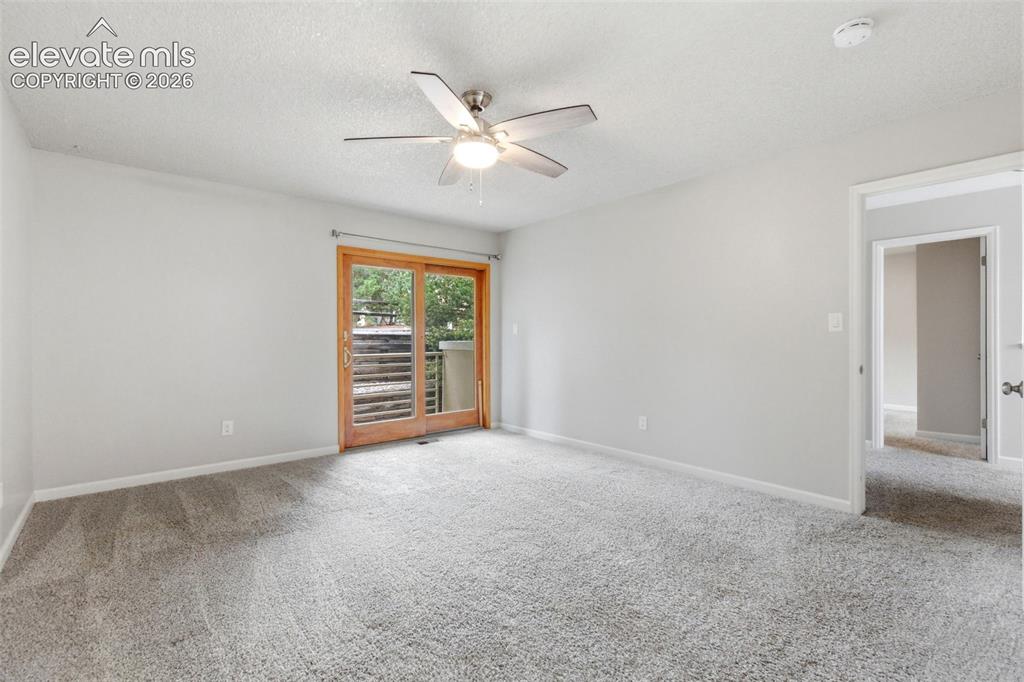 Image 25 of 50: Spacious room featuring light gray carpeting, neutral wall finishes, and a