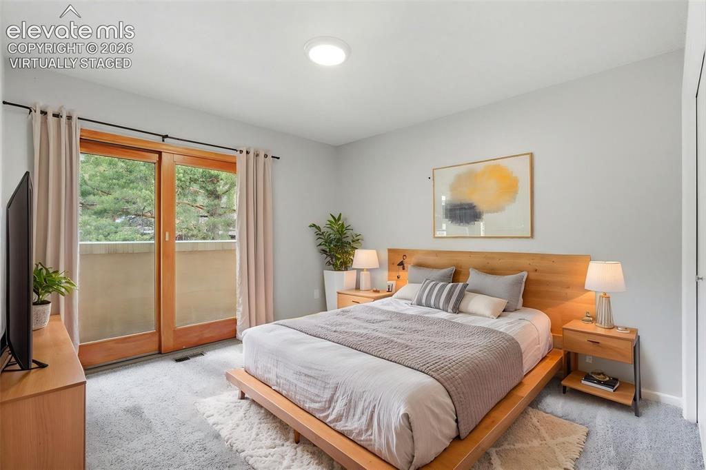 Image 38 of 50: Virtually Staged - Sliding glass doors opening to an exterior balcony, ligh