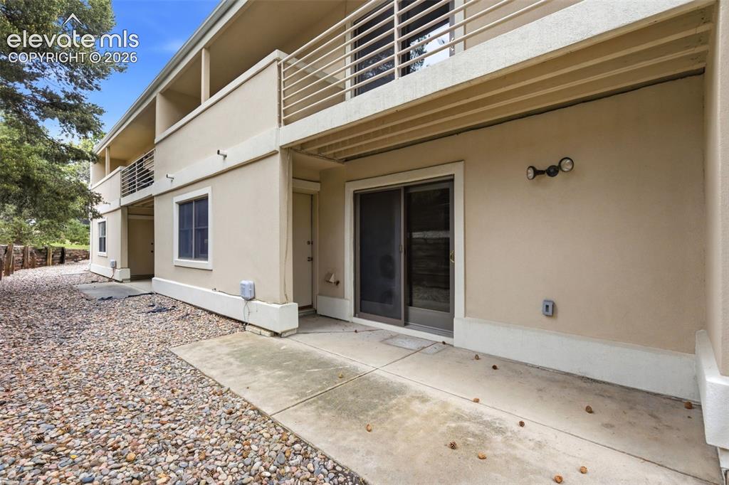 Image 45 of 50: Ground-level concrete patio with direct access to a sliding glass door