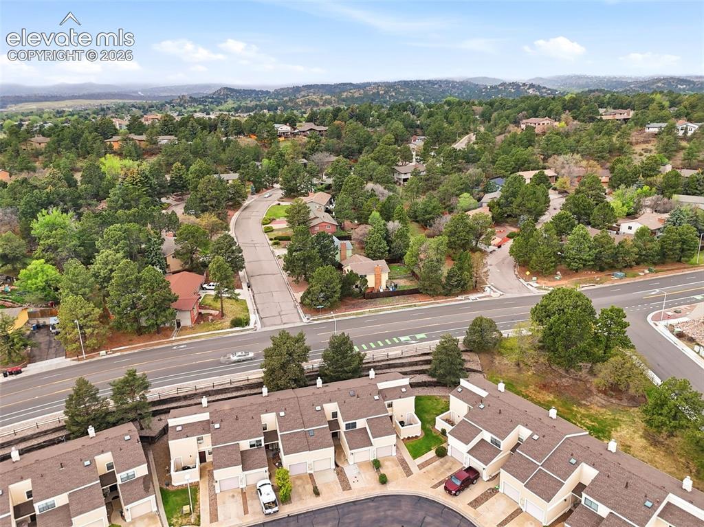 Image 46 of 50: Aerial perspective showcasing a residential area with townhomes and detache