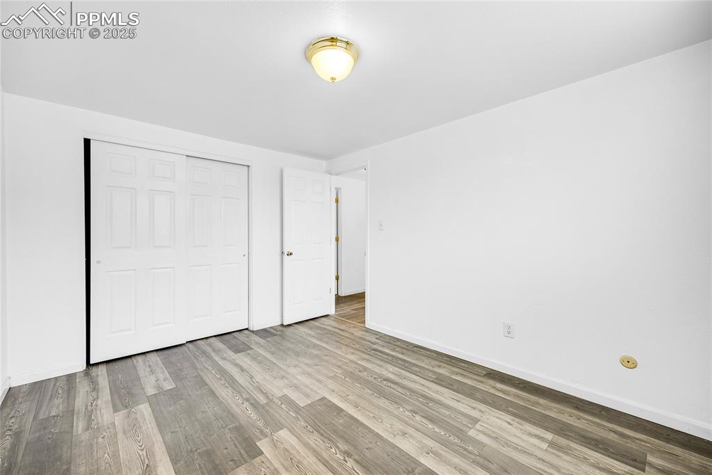 Image 17 of 24: Unfurnished bedroom featuring light wood-type flooring and a closet