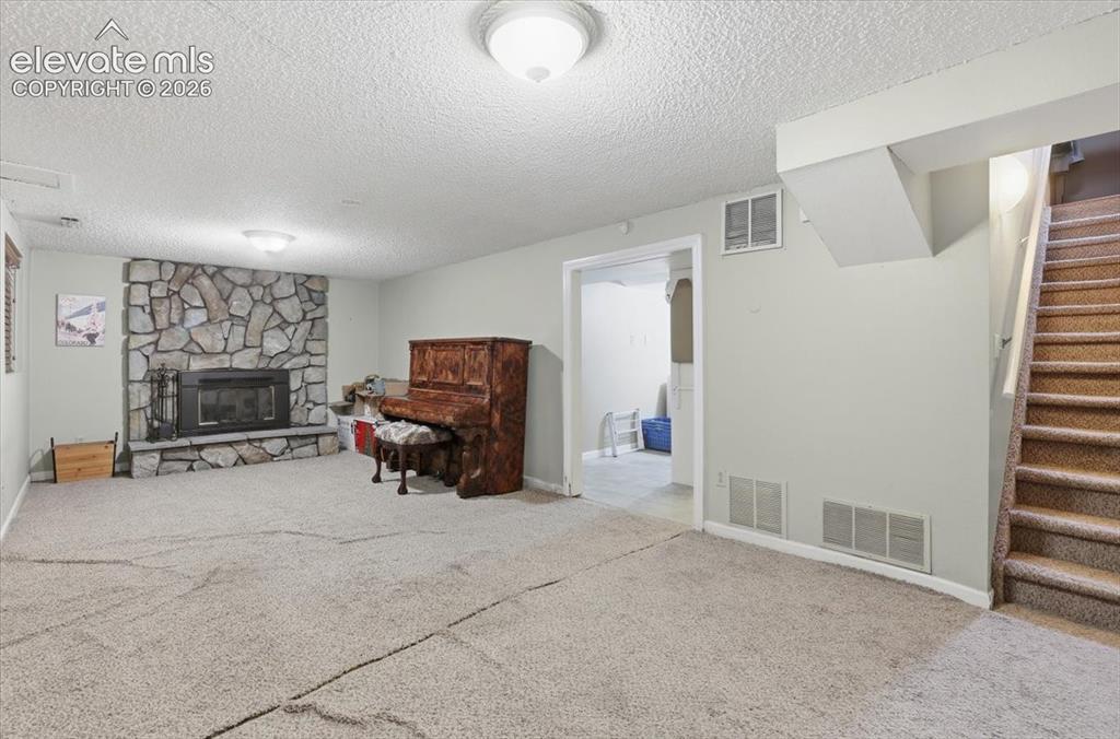 Image 41 of 50: Basement family room with fireplace
