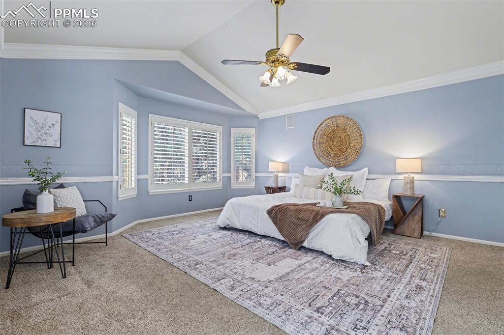 Image 18 of 44: Carpeted bedroom with ceiling fan and crown molding