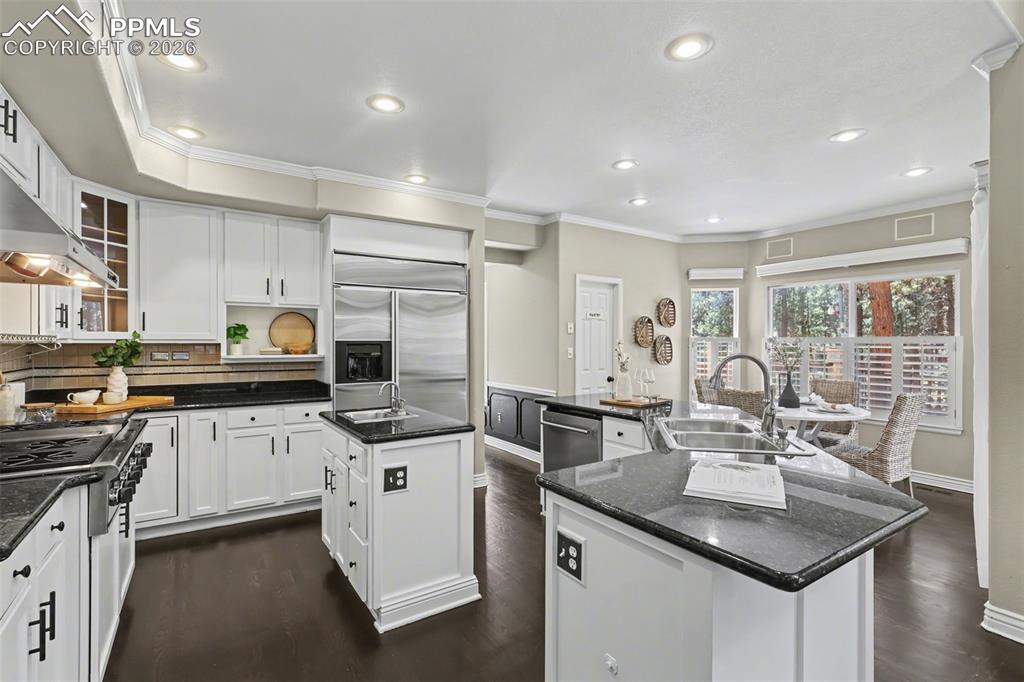 Image 7 of 44: Kitchen featuring ornamental molding, stainless steel appliances, glass ins