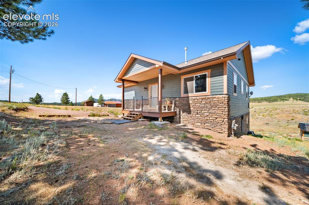 Image 1 of 41: Covered front porch with attractive stone accents.