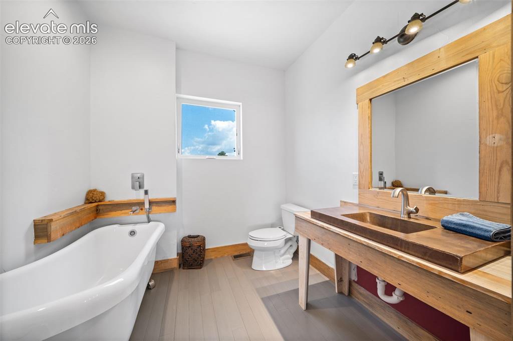 Image 13 of 41: Main-level bathroom with a freestanding soaking tub.