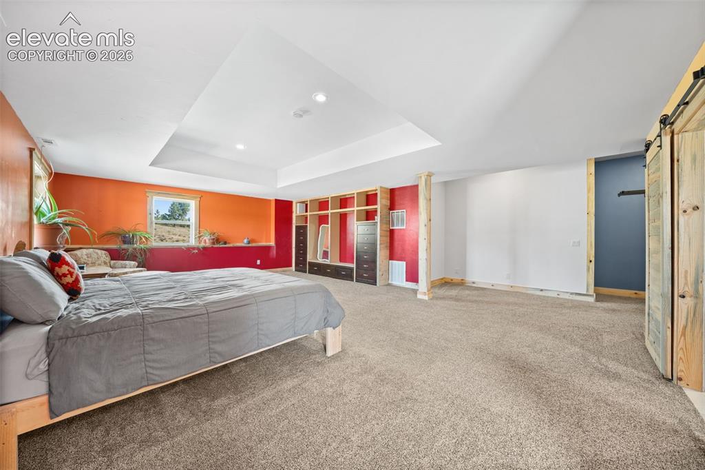 Image 15 of 41: Expansive walkout primary bedroom with abundant space.