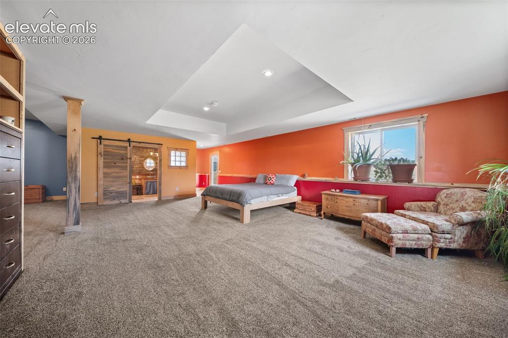 Image 16 of 41: Expansive walkout primary bedroom with abundant space.