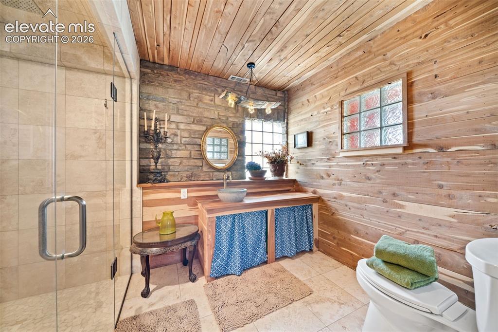 Image 19 of 41: Beautiful primary en-suite featuring a walk-in tile shower.
