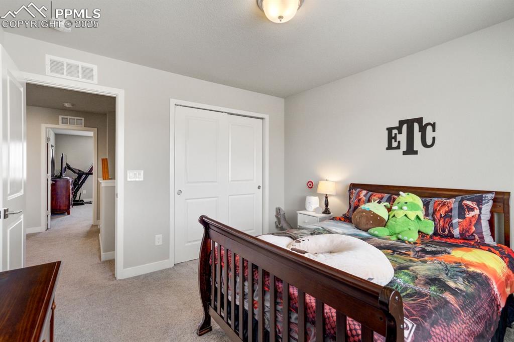 Image 35 of 50: Bedroom with light carpet, a closet, visible vents, and baseboards