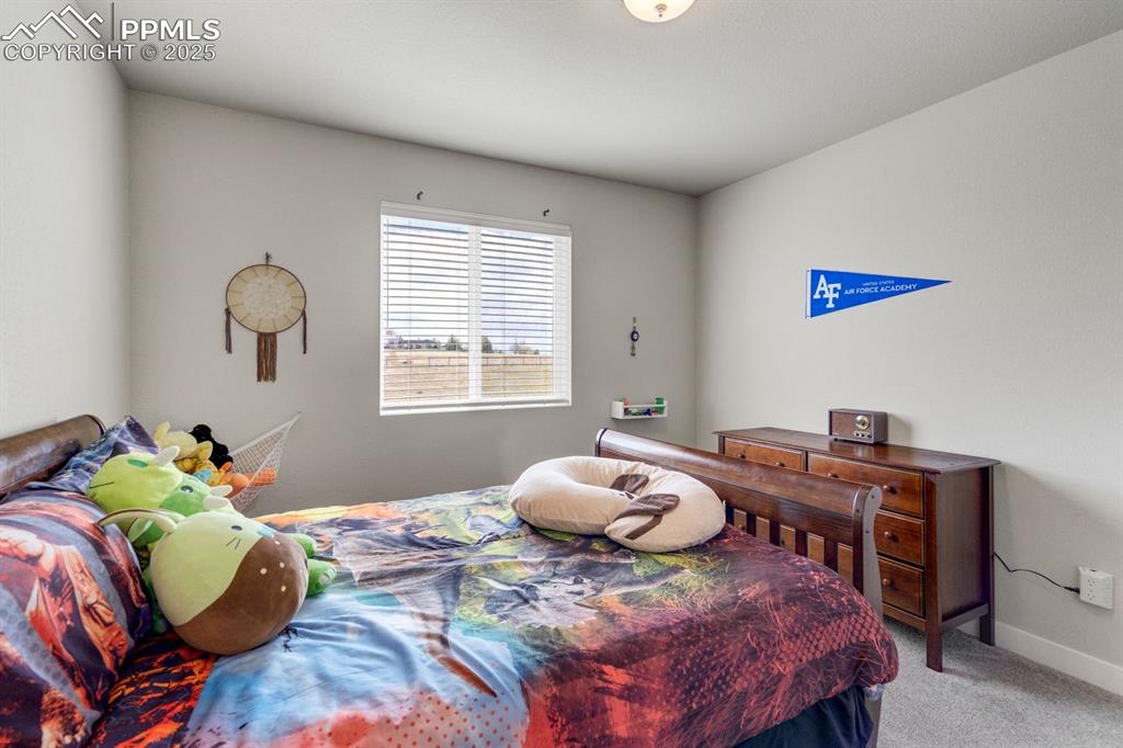 Image 36 of 50: Bedroom featuring baseboards and light carpet
