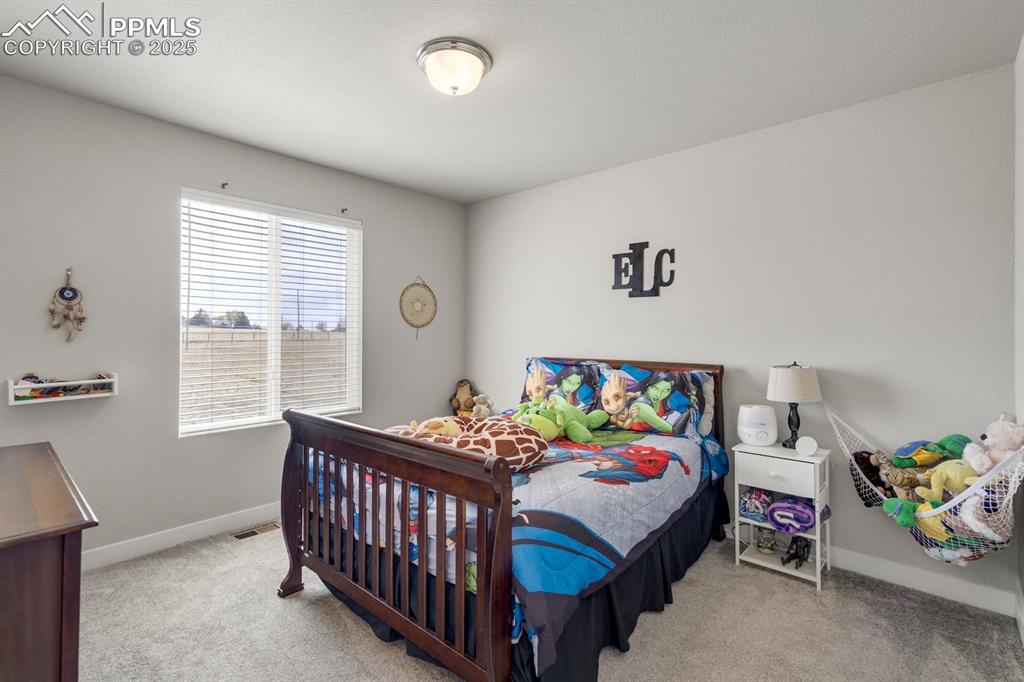 Image 37 of 50: Bedroom featuring carpet floors, visible vents, and baseboards