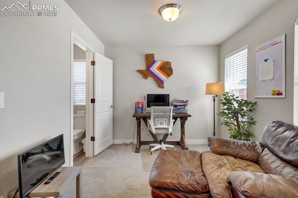 Image 4 of 50: Office space with baseboards and light colored carpet