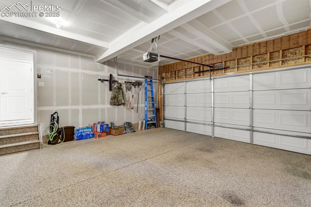 Image 41 of 50: Garage with a garage door opener