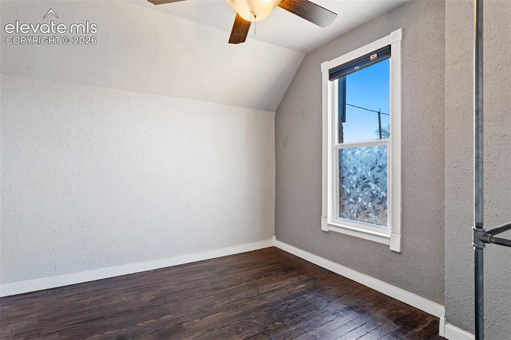 Image 20 of 35: Room featuring dark wood-finish flooring and a white trimmed window