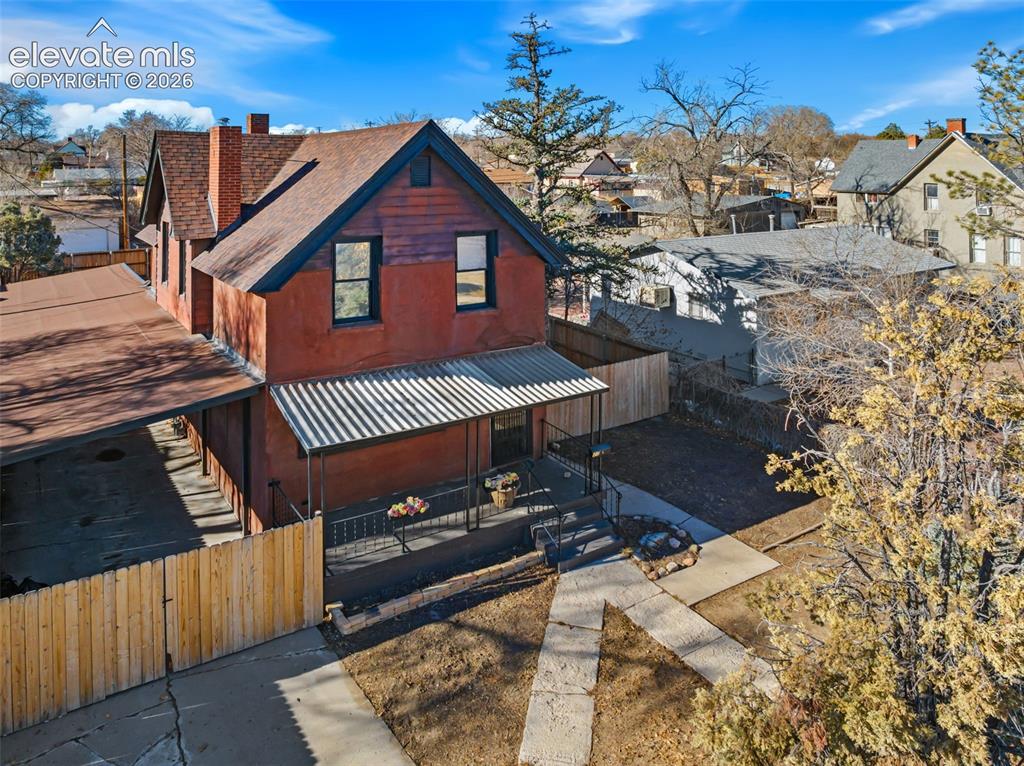 Image 29 of 35: Two-story property featuring a reddish-brown facade and a distinctive brick
