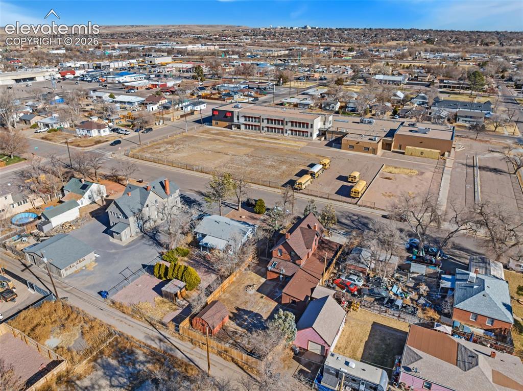 Image 33 of 35: Aerial overview of a developed urban area featuring residential and commerc