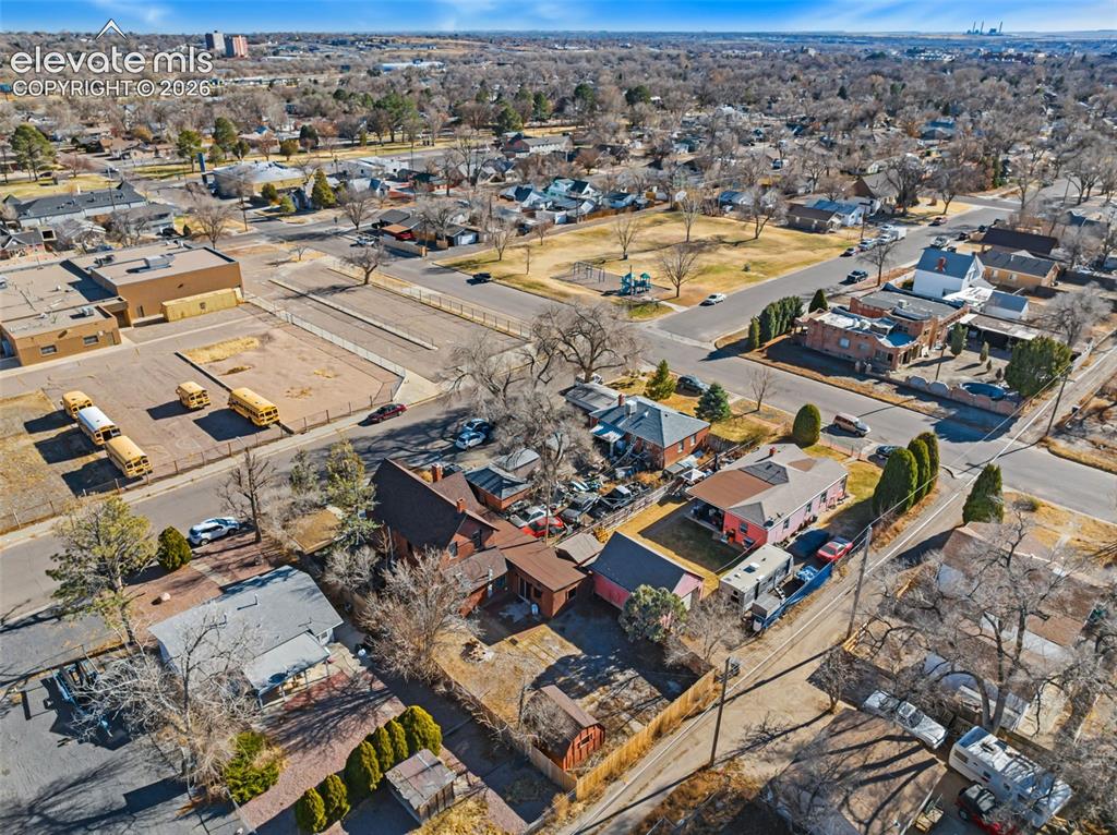 Image 35 of 35: Aerial perspective of a developed neighborhood with mature trees and a park
