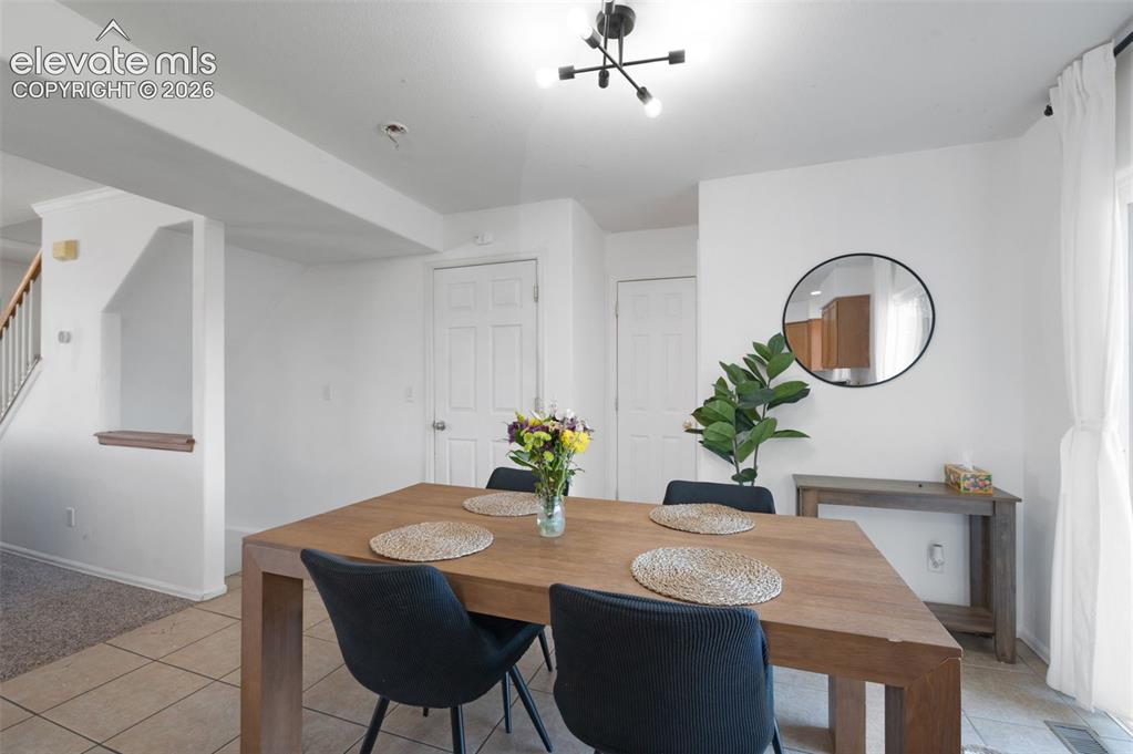 Image 13 of 31: Dining area featuring tile flooring, a contemporary ceiling light fixture,