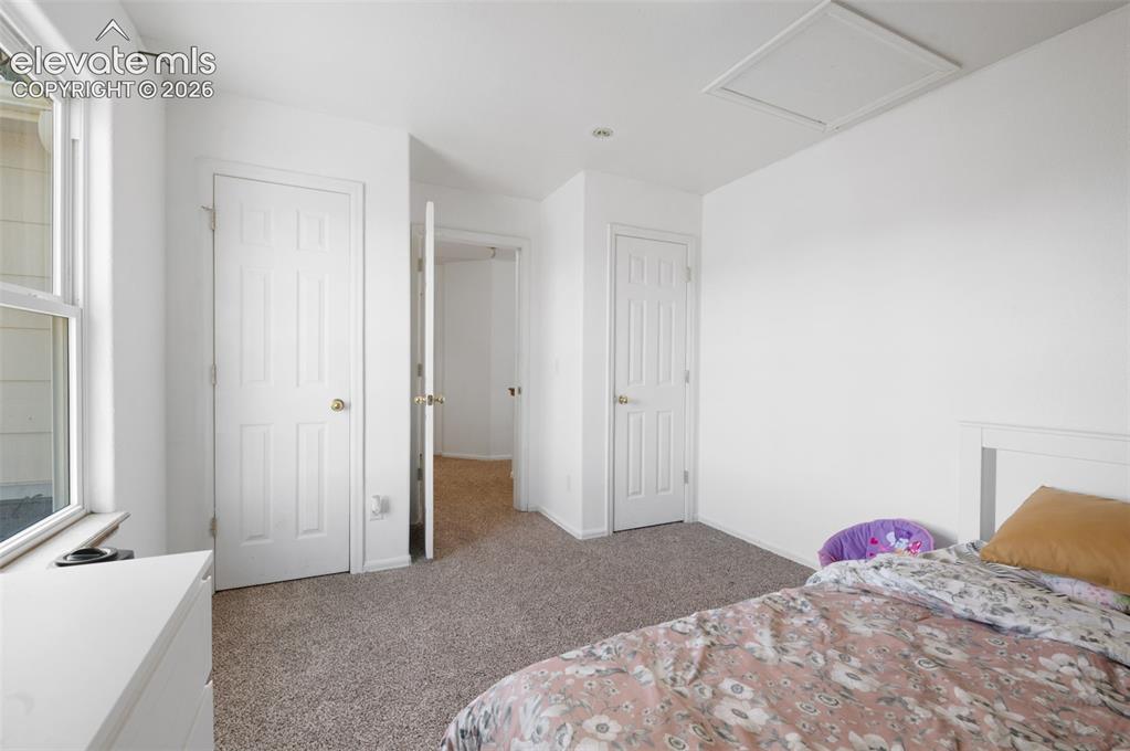 Image 21 of 31: Carpeted room with a double-pane window, white trim, and a white six-panel