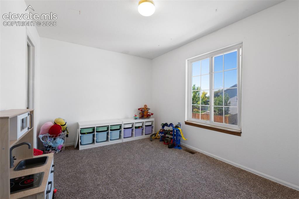Image 22 of 31: Bright room featuring a large window with white framing and a wood sill