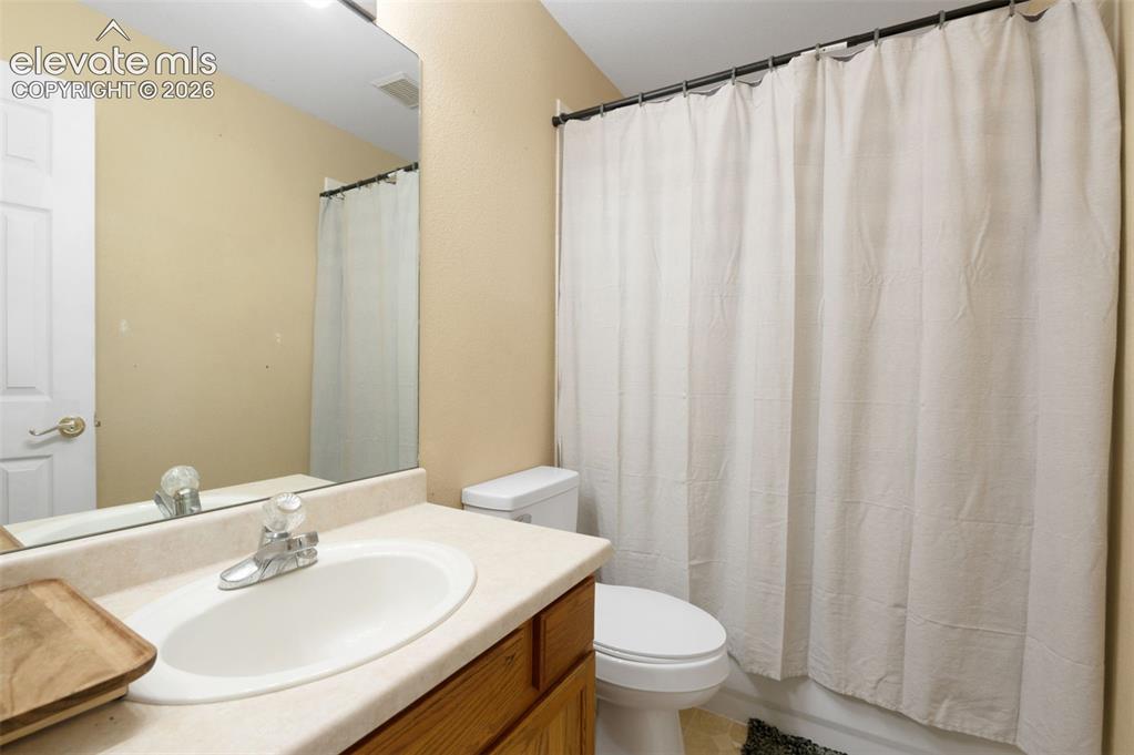 Image 26 of 31: Bathroom vanity featuring an integrated sink with a chrome faucet, set with