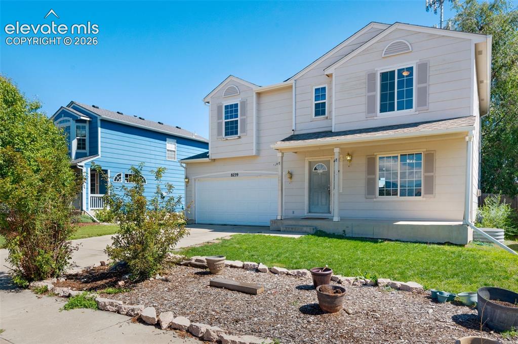 Image 3 of 31: Two-story residence featuring light-colored siding, a covered front porch,