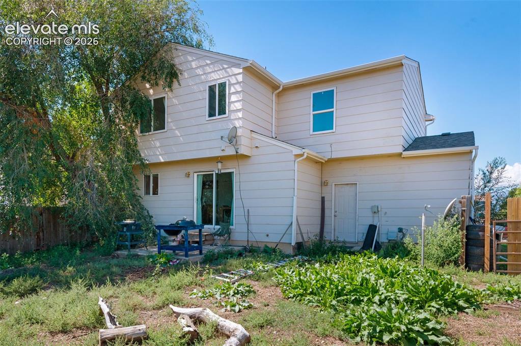 Image 31 of 31: Beige siding exterior with multiple windows