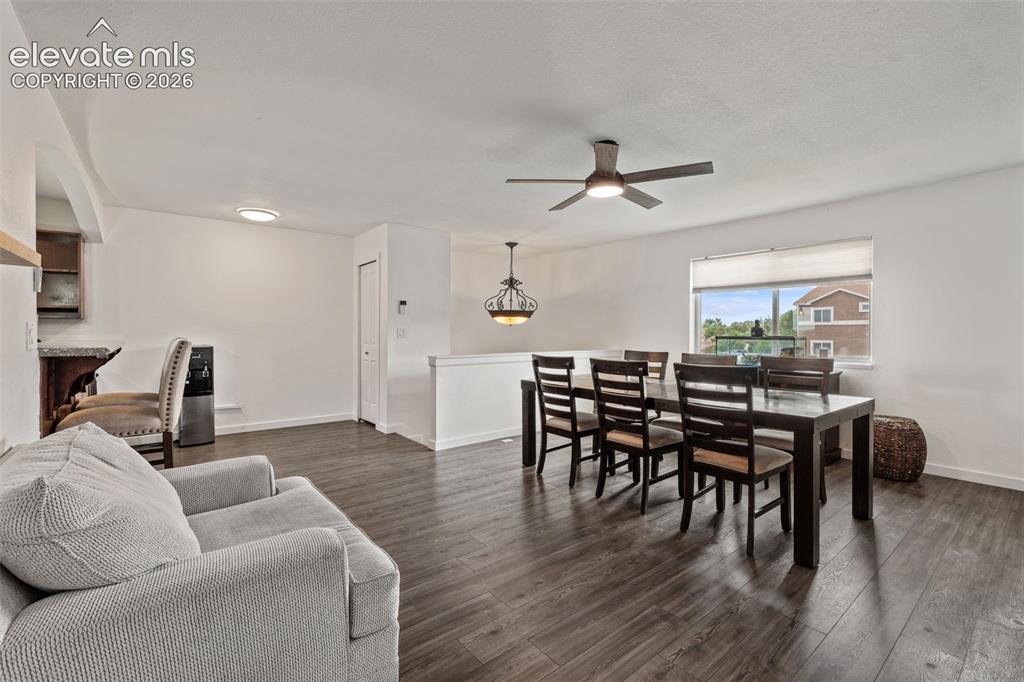 Image 12 of 43: Open-concept living area with wood-finish flooring