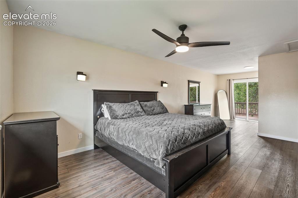 Image 18 of 43: Spacious room featuring wood-finish flooring, a contemporary ceiling fan wi