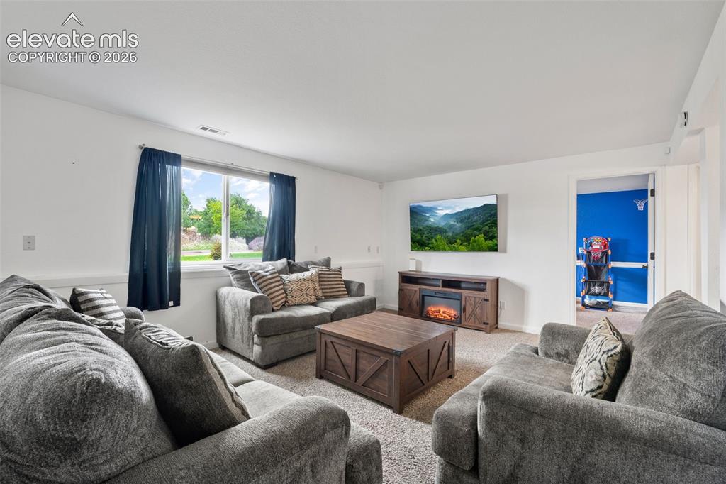 Image 22 of 43: Spacious room featuring neutral carpet flooring and white walls