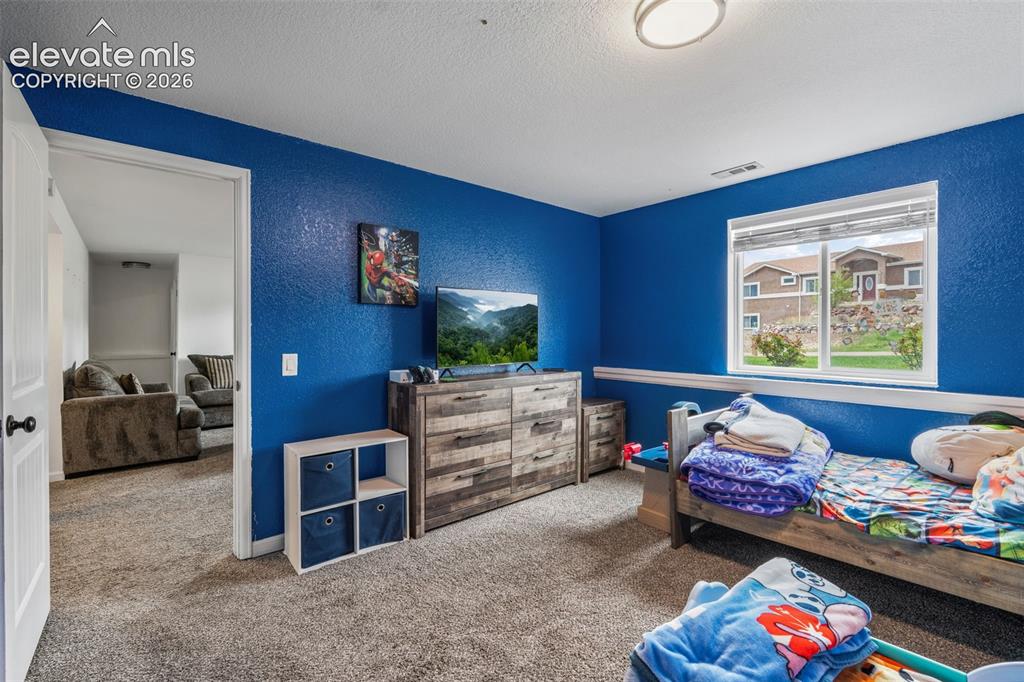 Image 25 of 43: Spacious room featuring carpeting, a white window frame, and a white interi