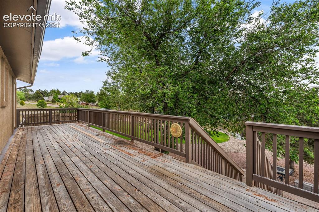 Image 29 of 43: Expansive wood deck with a full railing system