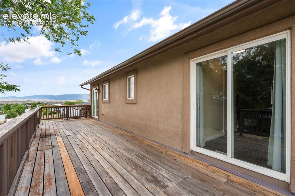Image 30 of 43: Expansive wooden deck featuring perimeter railing