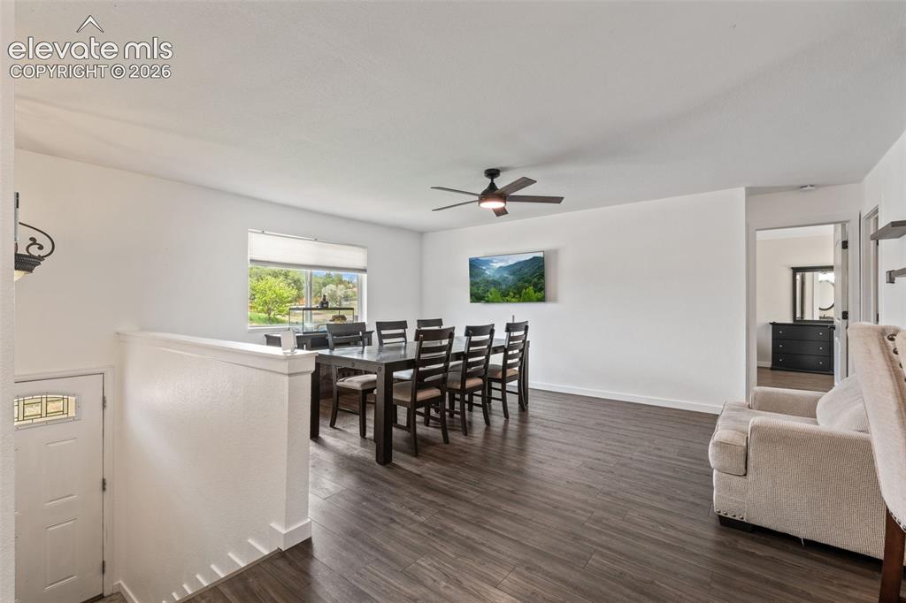 Image 9 of 43: Open-concept living space featuring wood-finish flooring, a contemporary ce