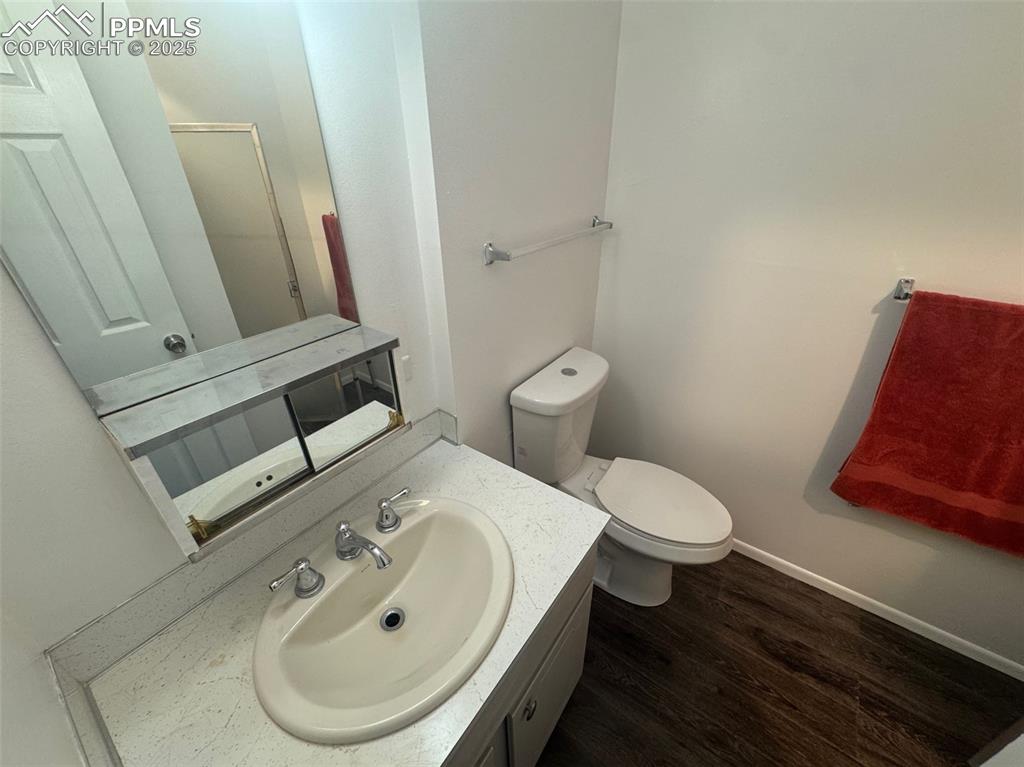 Image 16 of 30: Bathroom featuring vanity and dark wood-style flooring
