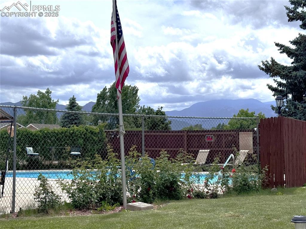 Image 21 of 30: Community pool featuring a mountain view