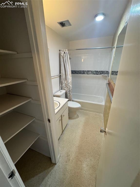 Image 9 of 30: Bathroom featuring vanity and shower / bath combination with curtain