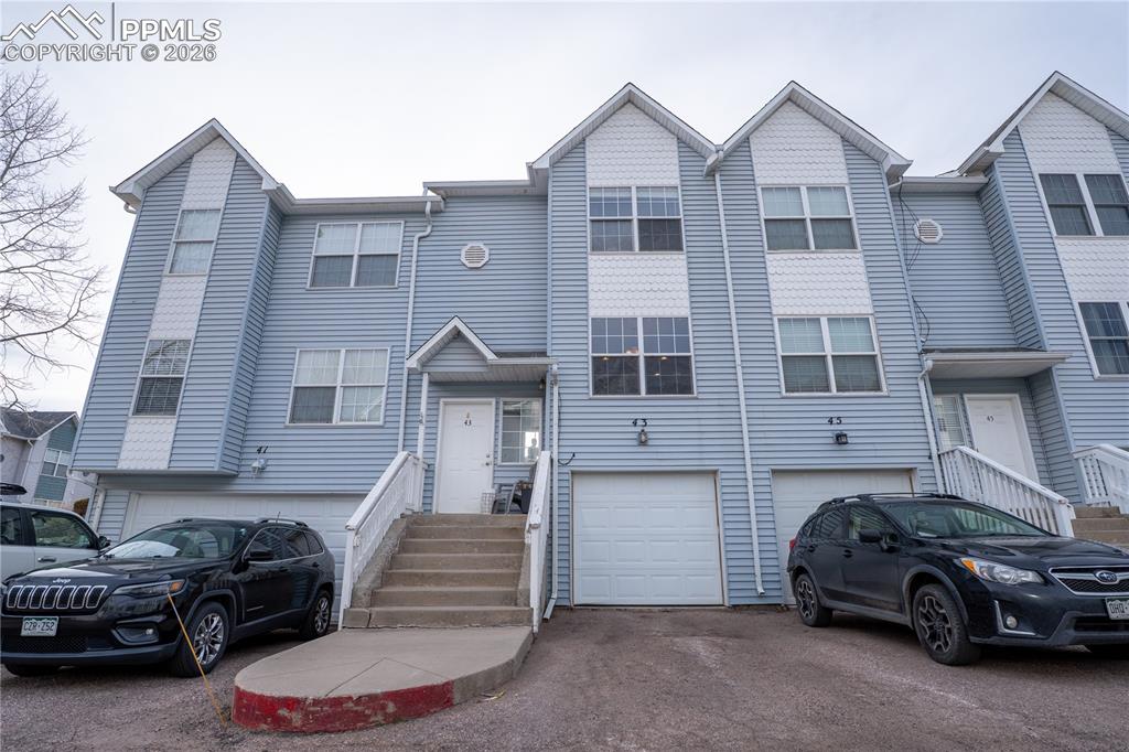Image 1 of 23: View of front of property with driveway and a garage